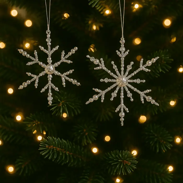 Elegant beaded Christmas snowflake ornaments shining in light.